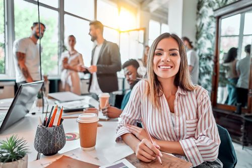 male and female healthcare strike recruiters smiling from work desk